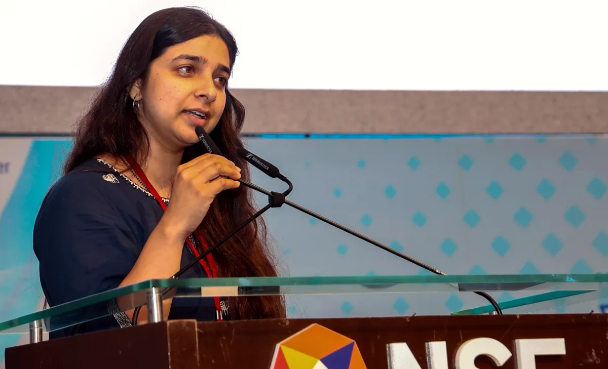 Presenting BioMarkIQ at a podium bearing the NSE logo.