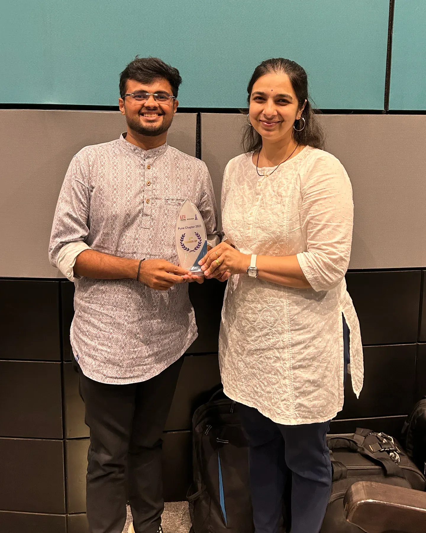 Manasi Khasnis and a colleague hold a TiE Pune Women trophy reading Pune Chapter 2023, 2nd Runner Up.